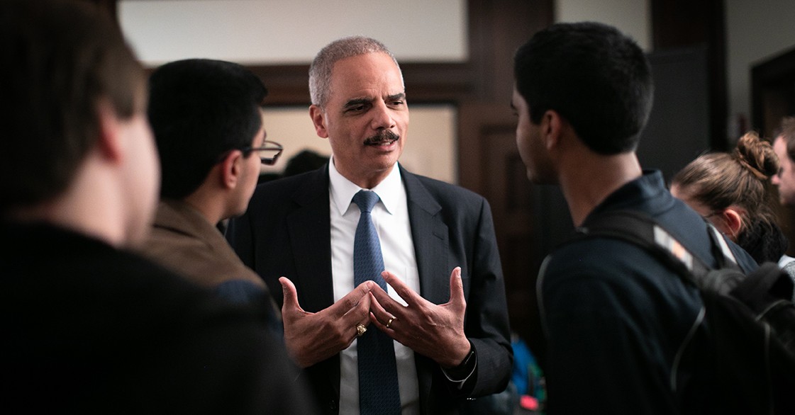 Eric Holder speaks with a group of students