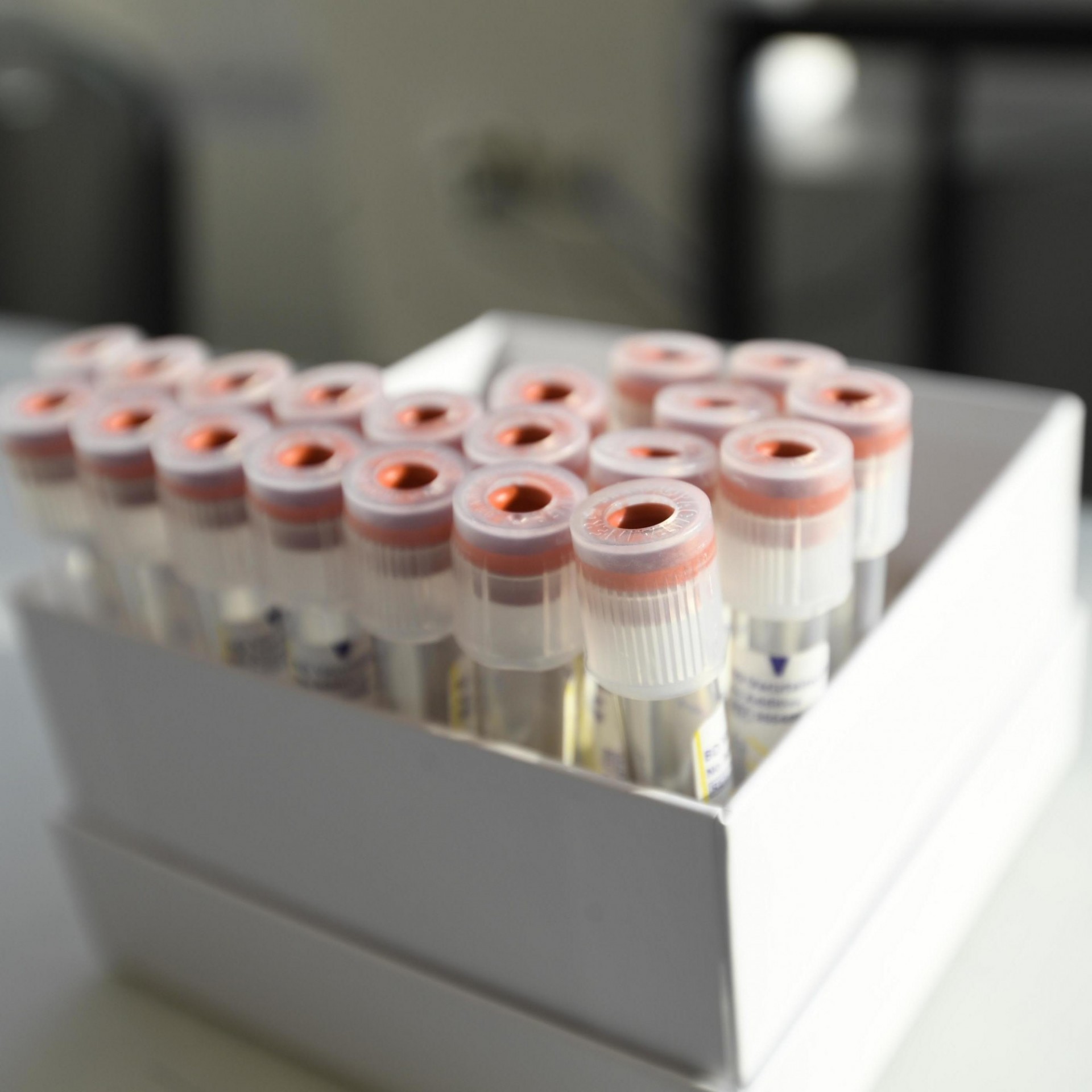 A box of labeled COVID-19 testing vials